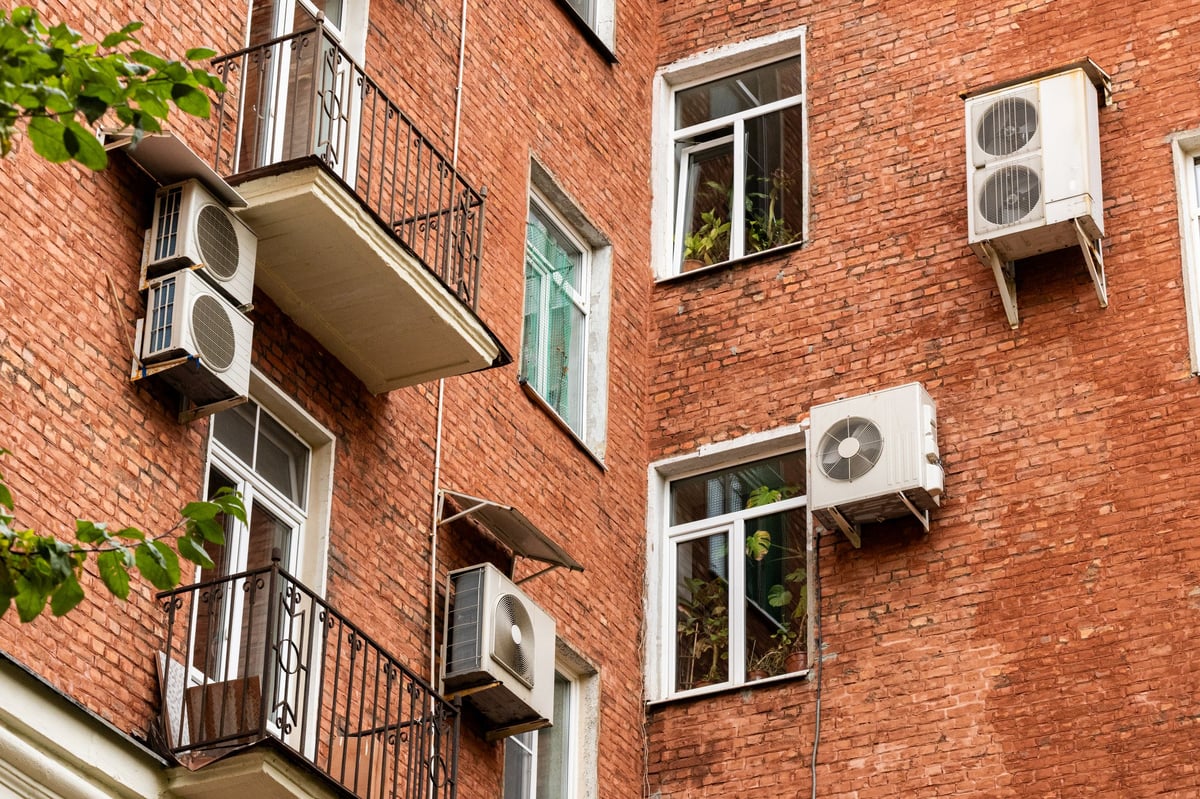 Unidad de aire acondicionado tipo condensador instalada en el exterior de una casa